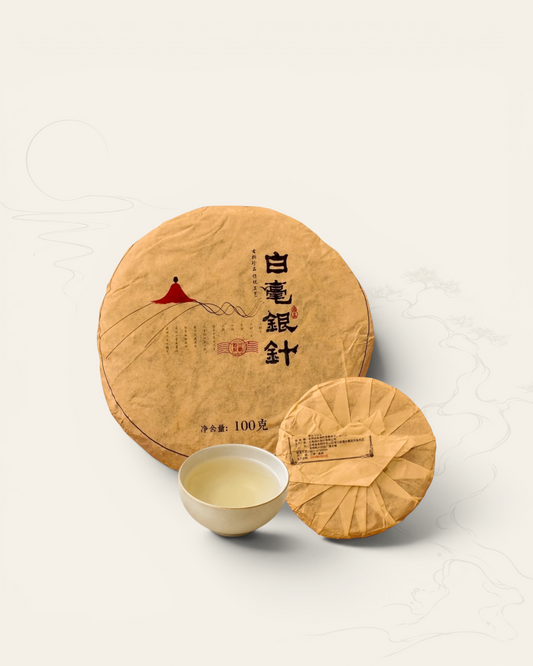 Bai Hao Yin Zhen white tea disc — single-bud pressed white tea from Yunnan