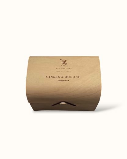 Ginseng Oolong tea birch wood tea box on a light background
