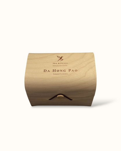 Da Hong Pao oolong tea birch wood tea box on a light background
