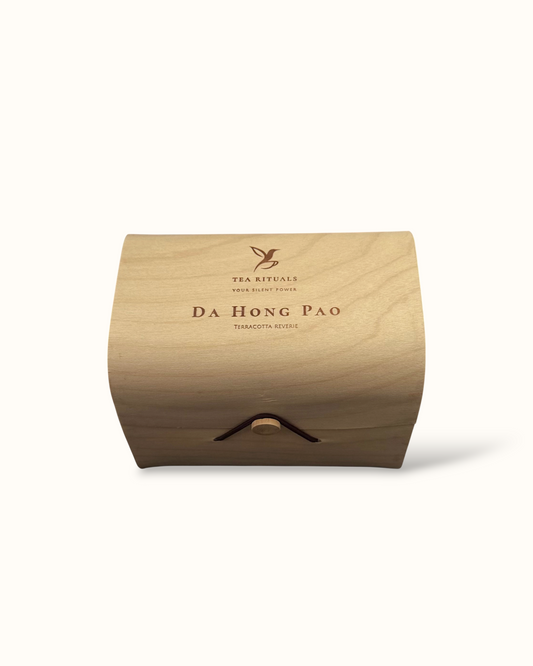 Da Hong Pao oolong tea birch wood tea box on a light background
